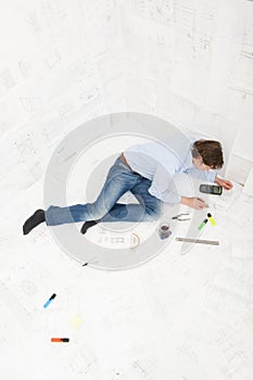 Engineer surrounded by technical drawings