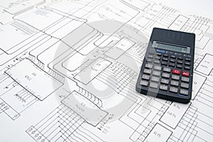 Engineer table with schematics and calculator photo
