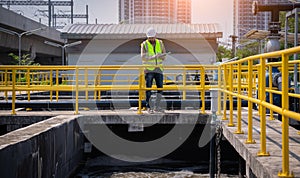 Engineer take water from  wastewater treatment pond to check the quality of the water. After going through the wastewater treatmen