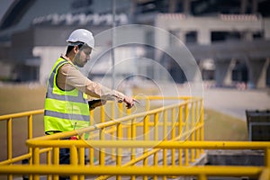 Engineer take water from  wastewater treatment pond to check the quality of the water. After going through the wastewater treatmen