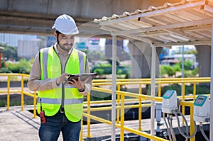 Engineer take water from  wastewater treatment pond to check the quality of the water. After going through the wastewater treatmen