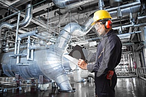 Engineer taking notes at thermal power plant factory