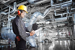 Engineer taking notes at thermal power plant factory