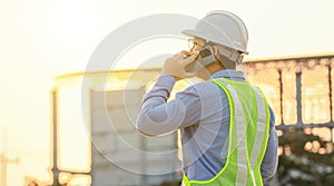 Engineer talk on mobile phone at construction site