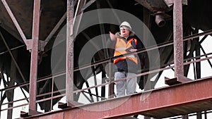 Engineer talking near tanks