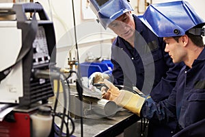 Engineer Teaching Apprentice To Use TIG Welding Machine