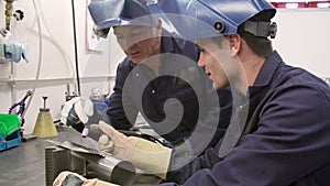 Engineer Teaching Apprentice To Use TIG Welding Machine