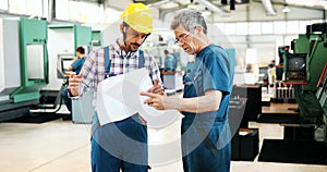 Engineer Teaching Apprentices To Use Computerized cnc metal processing machines