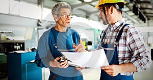 Engineer Teaching Apprentices To Use Computerized cnc metal processing machines