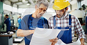 Engineer Teaching Apprentices To Use Computerized cnc metal processing machines