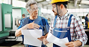 Engineer Teaching Apprentices To Use Computerized cnc metal processing machines