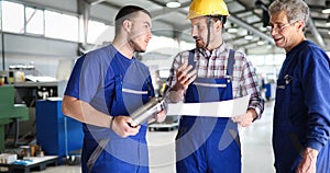 Engineer Teaching Apprentices To Use Computerized cnc metal processing machines