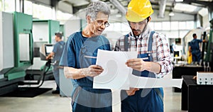 Engineer Teaching Apprentices To Use Computerized cnc metal processing machines