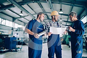 Engineer Teaching Apprentices To Use Computerized cnc metal processing machines