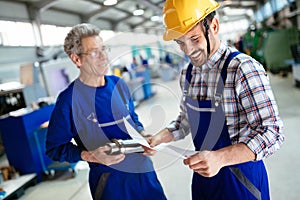 Engineer Teaching Apprentices To Use Computerized cnc metal processing machines