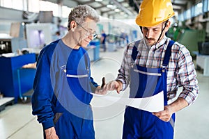 Engineer Teaching Apprentices To Use Computerized cnc metal processing machines