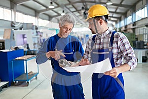 Engineer Teaching Apprentices To Use Computerized cnc metal processing machines
