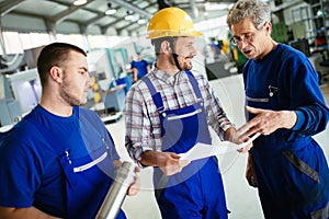Engineer Teaching Apprentices To Use Computerized cnc metal processing machines