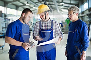 Engineer Teaching Apprentices To Use Computerized cnc metal processing machines
