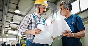 Engineer Teaching Apprentices To Use Computerized cnc metal processing machines