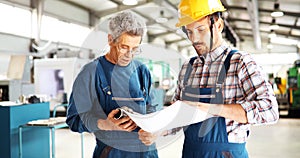 Engineer Teaching Apprentices To Use Computerized cnc metal processing machines