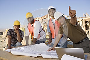 Engineer With Team Of Architects At Site