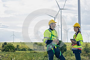 Engineer team man and woman field working together survey plan construction wind turbine clean power generator