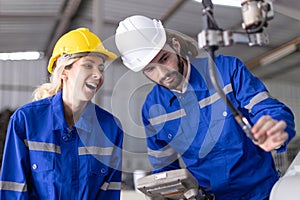 Engineer team man and woman working together training help support work with robot welding machine service