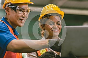 engineer team mix race man and woman working together in heavy industry with laptop computer discussion, join helping engineer