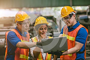 engineer team mix race man and woman working together in heavy industry with laptop computer discussion, join helping engineer