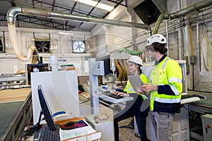 engineer team staff worker working in wooden furniture factory control operate wood cutter machine