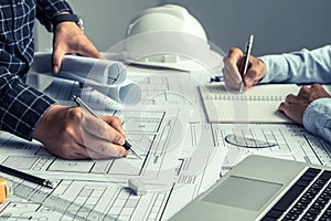 engineer team working in office with blue prints.Team of architects people