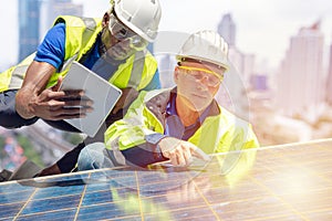 Engineer team working setup Solar panel at the roof top of business building. Teamwork work together to install maintenance