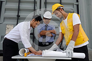 Engineer team writing construction plan on paper