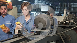 Engineer teams inspect machines` electric current at the industry factory.