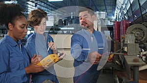 Engineer teams inspect machines` electric current at the industry factory.