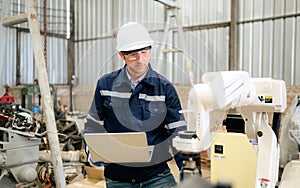 Engineer technician controlling robotic arms on computer laptop