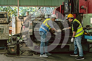 Engineer technician teamwork consulting problem together service maintenance old machine for safety in heavy industry factory