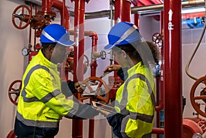 Engineer or technician work checking Fire suppression system and fire equipment. Engineer check red generator pump for water sprin