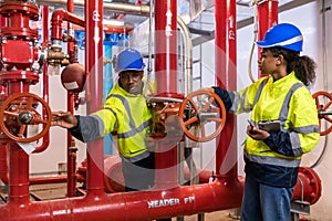 Engineer or technician work checking Fire suppression system and fire equipment. Engineer check red generator pump for water sprin