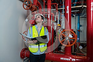 Engineer or technician work checking Fire suppression system and fire equipment. Engineer check red generator pump for water sprin