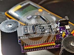 Engineer testing microcontroller board.