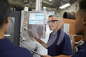 Engineer Training Apprentices On CNC Machine