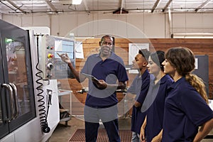 Engineer Training Apprentices On CNC Machine photo