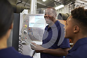 Engineer Training Apprentices On CNC Machine