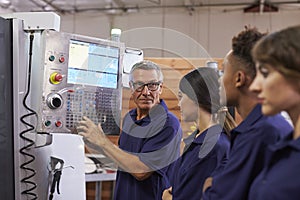Engineer Training Apprentices On CNC Machine photo