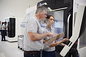 Engineer Training Female Apprentice To Use CNC Machine In Factor