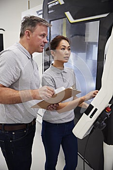 Engineer Training Female Apprentice To Use CNC Machine In Factor