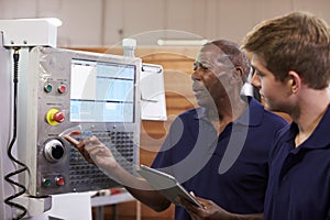 Engineer Training Male Apprentice On CNC Machine