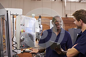 Engineer Training Male Apprentice On CNC Machine